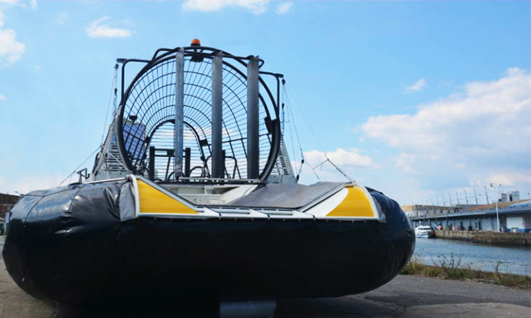 Air Boat Hybrid craft prototype - transition test to amphibious mode with inflated air cushion (on the ground 2018) Seen from behind.